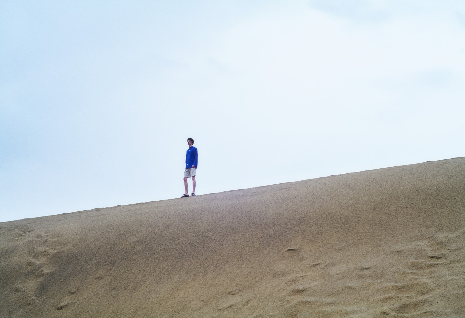 砂漠の上に男性が立っている画像
